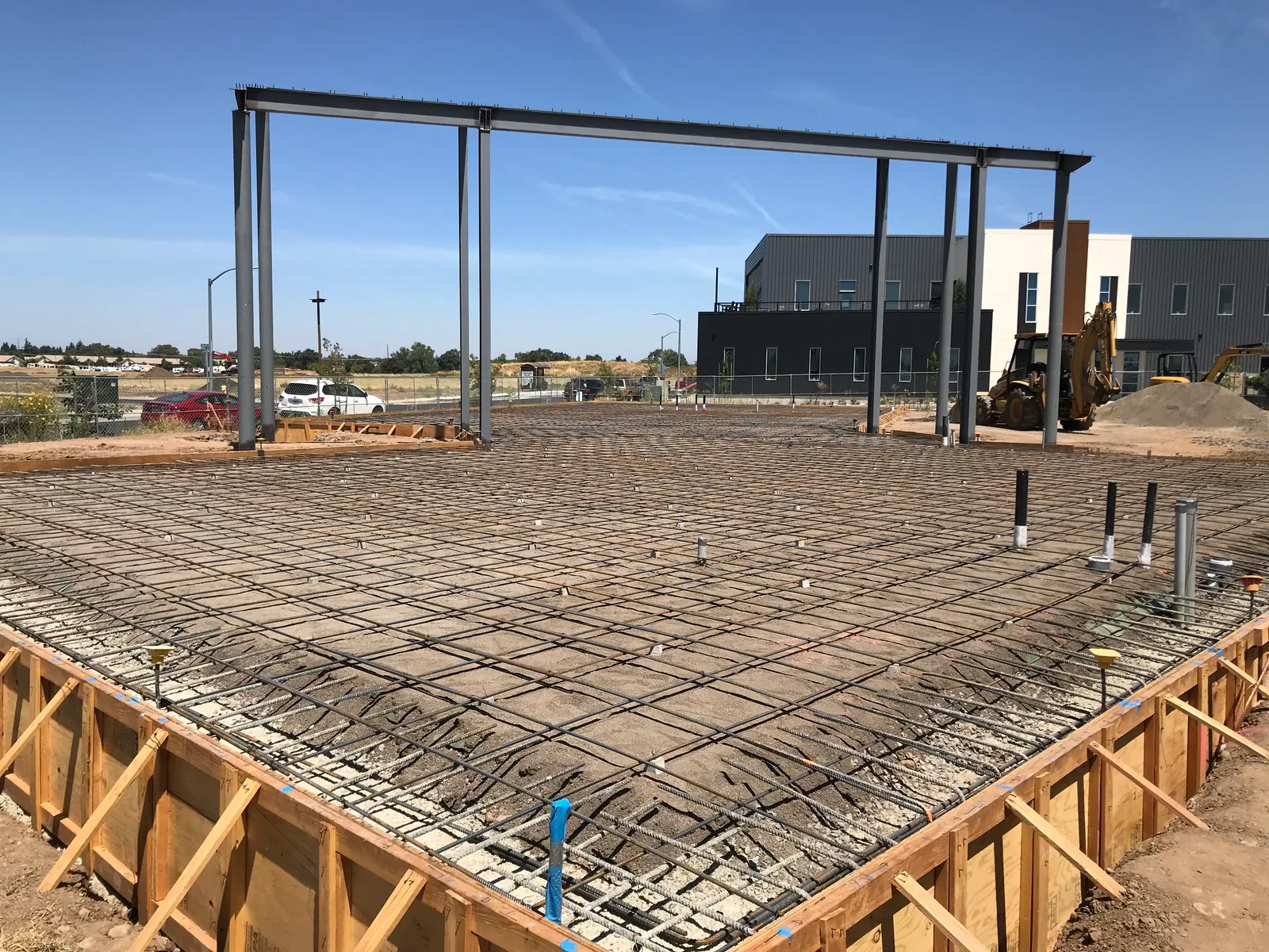 Reinforcing steel and timber forms prepared for a commercial concrete slab