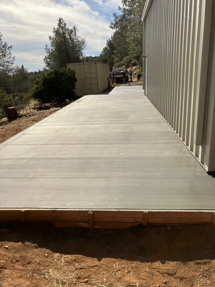 Finished concrete apron alongside a metal building
