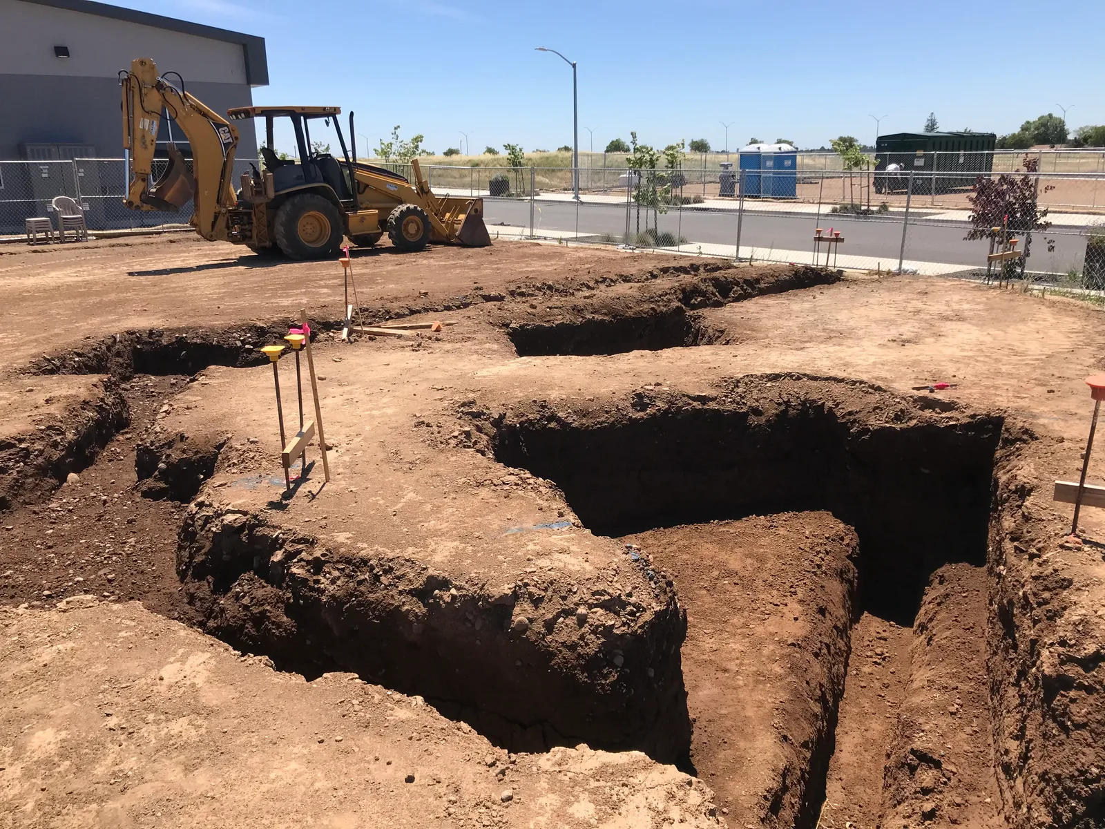Excavated foundation footings on a commercial construction site